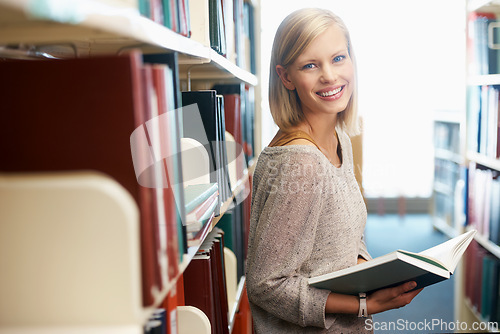 Image of Woman, portrait and book in library for reading as student for university education, scholarship or knowledge. Female person, face and research for revision or Canada for lesson test, exam or degree