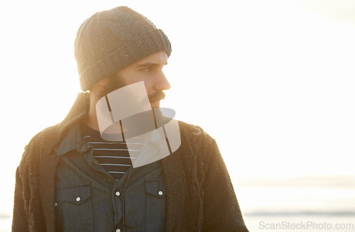 Image of Man, nature and winter fashion by beach for cold, comfort and protection in cape town weather climate. English guy, thinking and trendy clothes of scarf, beanie and idea by overcast ocean in morning