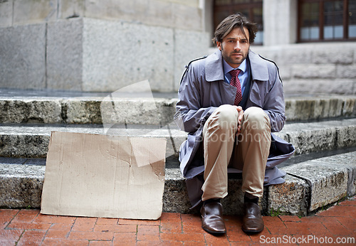 Image of Homeless, business or man with cardboard, unemployed in city or professional with recession or begging. Person, outdoor or financial criss with worker or stock market crash with job loss with poverty