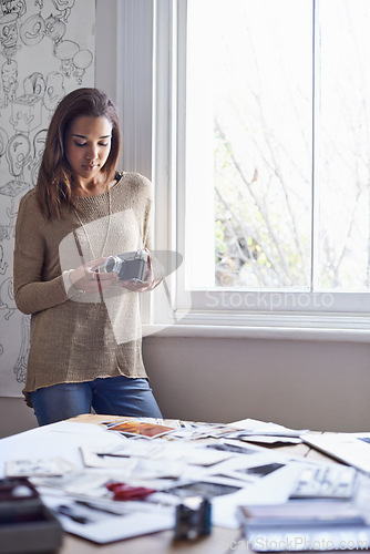 Image of Woman, photographer and vintage camera in creative studio with images of portfolio or art project, proposal or career. Female person, equipment and pictures or concept board or retro, hobby or prints