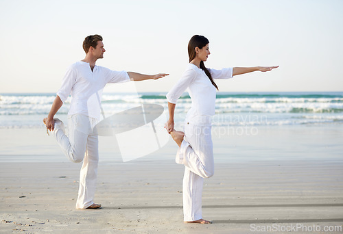 Image of Couple, yoga and balance, fitness on beach for zen and wellness, travel and mindfulness with holistic healing. People outdoor, exercise and pose, workout together for bonding with ocean and nature