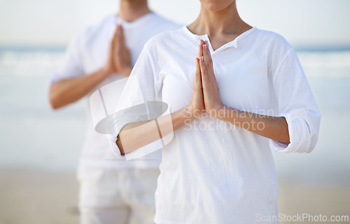 Image of Pilates, yoga and hands of couple on beach in morning for fitness, exercise and mindfulness in lotus pose. Nature, love and man and woman by ocean for meditation, wellness and healthy body outdoors