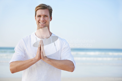 Image of Man, yoga and beach with smile in portrait for peace, zen and space for mockup on vacation with meditation. Person, ocean and outdoor in summer for namaste with nature on spiritual journey by sea