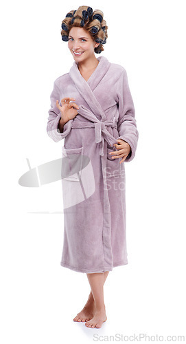 Image of Portrait, hair and bathrobe with woman curling in studio isolated on white background for pampering. Smile, beauty and wellness with happy young person in bathroom to relax for haircare treatment