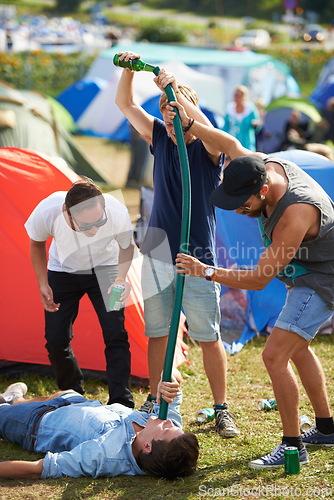 Image of Beer, festival or drunk friends drinking together on vacation or outdoor social event in summer. Music concert, crazy party games celebration or excited people with hose funnel or alcohol pipe tube