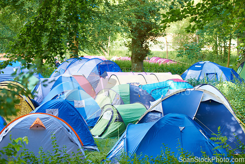 Image of Camping, tents and outdoor music festival in park on holiday or vacation in summer forest. Camp, site and shelter setup at party, event or travel in woods for concert, adventure and crowded carnival