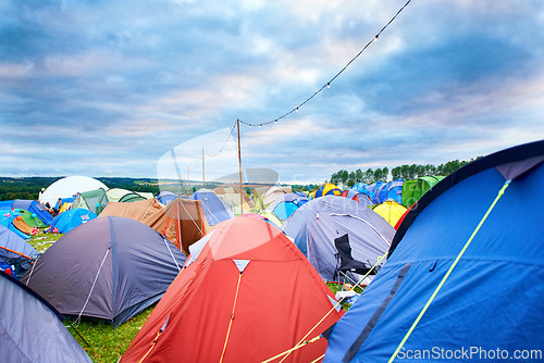 Image of Camping, tents and outdoor music festival in park on holiday or vacation in summer. Camp, site and shelter setup at party, event or travel in countryside for concert, adventure and crowded carnival