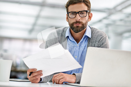 Image of Businessman, portrait and laptop with paperwork in finance, budget planning or investment at office. Man, accountant or employee with documents, financial report or policy by computer at workplace