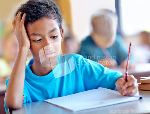 Image of Student, boy and writing notes for studying in classroom, book and problem solving at school. Male person, child and information for exam prep in notebook, solution and journal for assessment or test