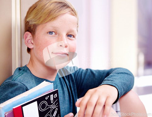 Image of Student, portrait and boy with book in hallway with education, study and textbook for back to school. Youth, young kid and learning on ground on campus with child and happy from class and break