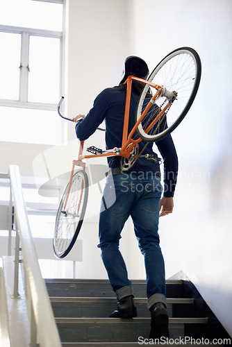 Image of Bicycle, stairs and man with back carrying bike for healthy and eco friendly transportation for travel. Staircase, carry and cyclist with apartment building, take up and journey of walking steps