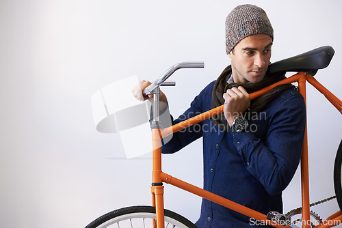 Image of Man, studio and bicycle for sustainability, transportation or exercise on white background. Hipster cyclist, carbon neutral and eco friendly travel for environmental commute or fitness and trip