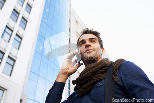 Image of Man, city and buildings with smartphone for phone call, conversation or networking in Chicago. Male person, technology and smile with communication, contact and happy in morning from low angle