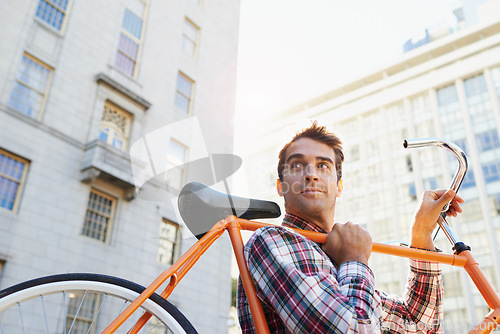 Image of Man, lifting bicycle and smile for travel, commute or journey to apartment in Chicago from behind. Male person, happy and road bike for sustainability, environmentally friendly and mobility in city