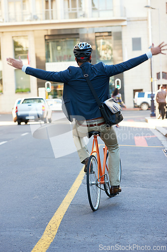 Image of Back, travel and bicycle with man, freedom and celebration with commute and adventure in a street. Person, outdoor and cyclist with a bike and eco friendly transportation with buildings or urban town