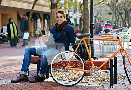 Image of Portrait, outdoor and smile with man, cellphone and bicycle with adventure and travel with internet and social media. Person, bench or New York with digital app and smartphone with connection or meme