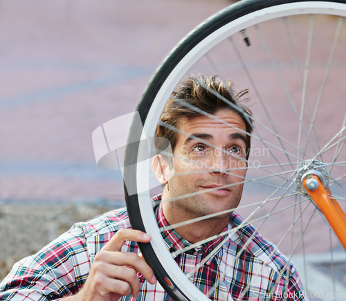 Image of City, inspection and man with bicycle wheel, maintenance and road with guy and transportation with sustainability. Check bike, person or hipster with cyclist and eco friendly with cycling or street
