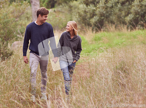 Image of Happy couple, walk and holding hands in the countryside, forest or summer outdoor for hiking on valentines day date. Smile, man and woman in nature for support, love or romantic connection together