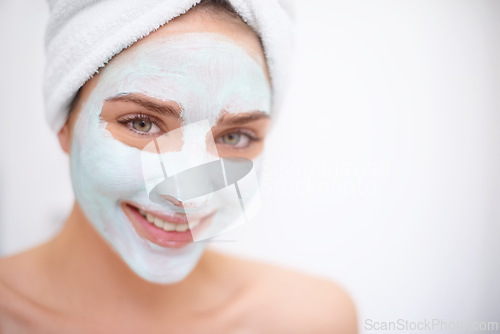 Image of Women, face mask and skin care for portrait, bathroom and acne for organic rejuvenation. Female person, towel and smile with treatment, wellness and spa day for beauty and relaxation for hygiene