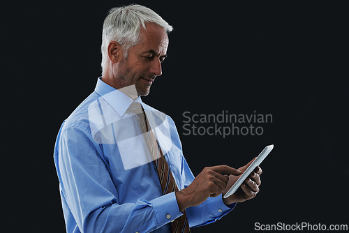 Image of Businessman, tablet and typing in studio for research, communication or networking with clients online. Male CEO, technology and scrolling for information, planning or working on black background