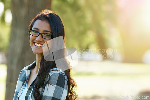 Image of Woman, portrait and relaxing in park or garden, smiling and joyful on summer holiday. Female person, eyewear and enjoying vacation in countryside, outdoors and calm student on weekend in nature