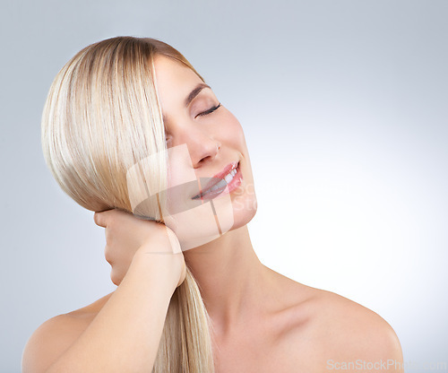 Image of Hair care, hand and beauty of blonde woman with eyes closed, makeup and isolated on a white studio background. Face, touch and hairstyle of happy model in cosmetics, hairdresser and salon treatment