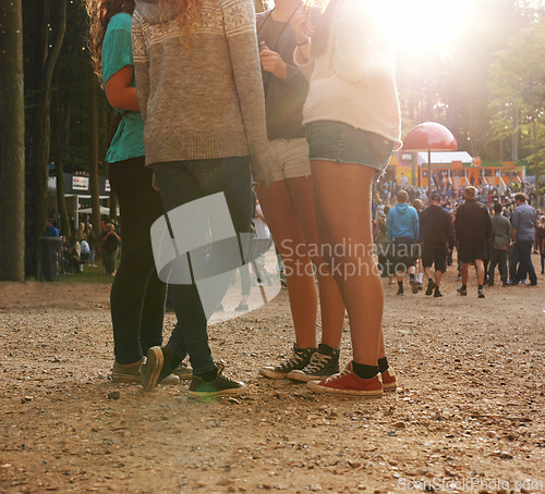 Image of Legs, forest and group of friends at festival together for social event, party or summer celebration. Flare, crowd and people in woods for talking, bonding or free time in nature with audience