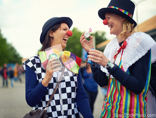 Image of Clown, people and outdoor at festival, carnival or costume for event or concert in park. Happy, women and smile in funny props, clothes and dress up for culture, party in summer or holiday bubbles