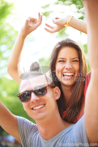 Image of Portrait, couple and excited at music festival in nature, holiday and celebration for young love in forest. Man, woman and happy face with hands in air, care and bonding together on vacation in woods