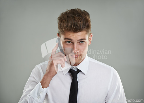 Image of Portrait, studio and man with phone call while meeting sales targets and KPI with gray background. Professional salesman, financial advisor or smartphone with shirt, tie or trendy haircut for mockup