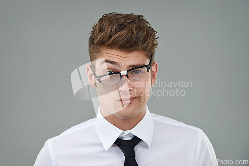 Image of Businessman, glasses and funny portrait in studio for optical healthcare, comedy and humor on gray backdrop. Male person, eyewear and joking with frame choice, optometry and lens for vision support