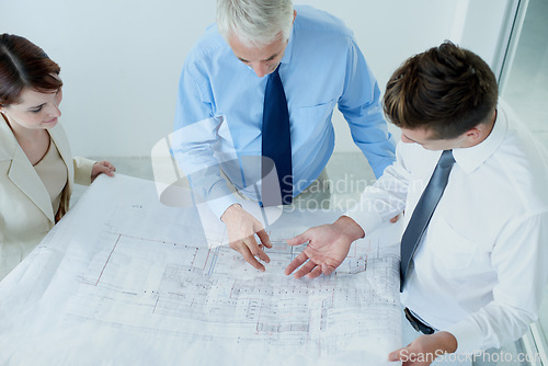 Image of Blueprint, above or civil engineering team planning project, maintenance or renovation in meeting. Architecture, people building or group of designers with floor plan ideas for property development