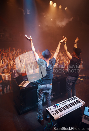 Image of Night, club and arms raised for dj at celebration with fans at stage for performance with piano and musician. Music festival, crowd and people with talent playing for audience in theater with energy