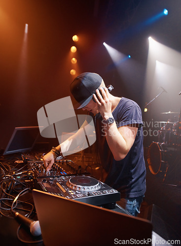 Image of DJ, headphones and audio on stage for sound check with turntables at concert in Australia. Male producer, mic and spotlights at club, party or festival for EP release, album or live music performance