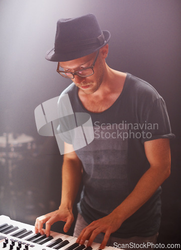 Image of Jazz musician, playing and piano on stage at night for solo performance and album launch in Canada. Hipster with electronic keyboard at rock, music and festival for sound, audio and live gig