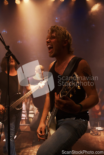 Image of Exciting, guitar and player for night, performance and live concert with rock band in Norway. Male guitarist, musician and instrument with spotlights for fundraising, music and event for charity