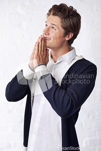 Image of Man is praying, happy and gratitude for worship or religion, spiritual and respect with belief on white background. Mindfulness, wellness and faith in God, hope and help with thank you in studio