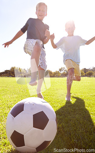 Image of Kids, soccer ball and field outdoor with fun, bonding and summer play with smile from sport. Running, happy and game with young children on a lawn for match with friends or sibling with football