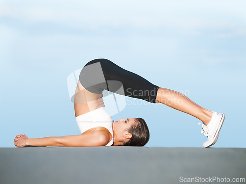 Image of Fitness, yoga and woman stretching body in studio for health, wellness and bending balance. Warm up, workout and girl with mindfulness, pilates and morning exercise on floor on blue background.