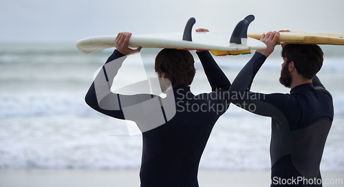 Image of Man, friends and surfer on beach for fitness, sport or waves on shore in outdoor exercise. Rear view of male person or people with surfboard for surfing challenge, tide or hobby by ocean in nature