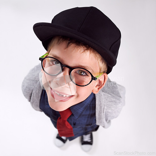 Image of Glasses, smile and portrait of child in studio for eye care, vision and optical health. Happy, optometry and top view of young boy kid with stylish eyewear or spectacles isolated by gray background.