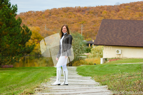 Image of Portrait of a young beautiful girl in casual clothes in a beautiful forest village