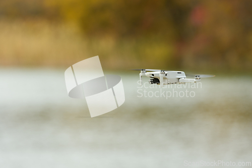 Image of Unmanned aerial vehicle close-up against the background of an autumn landscape