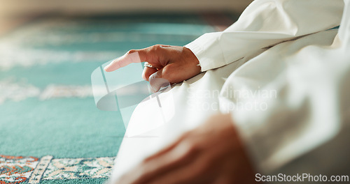 Image of Islam, floor and closeup of a pointing finger or person at a mosque for praying, hajj or support. Muslim, hope and hand of a man for a prayer, gesture or worship for respect, religion or trust