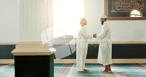 Image of Muslim, handshake and people in mosque for greeting, conversation and respect in Islamic community. Worship, friends and men shaking hands in religious building for Ramadan Kareem, prayer and support
