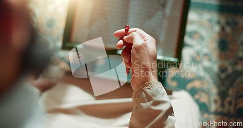 Image of Prayer beads, man in mosque reading Quran for Islam, mindfulness and gratitude in faith from above. Worship, religion and Imam in holy temple for praise with book, spiritual teaching and meditation.