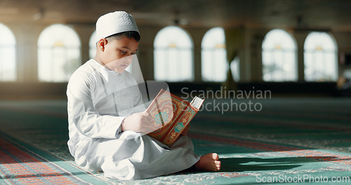 Image of Islam, boy in mosque reading Quran for learning mindfulness and gratitude in faith with kids prayer. Worship, religion and Muslim student in holy temple praise with book, spiritual teaching and study