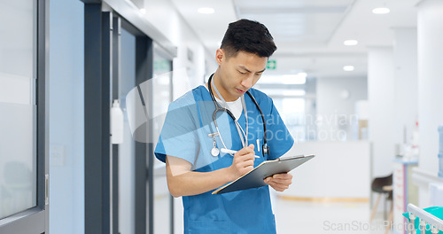 Image of Doctor, planning and writing in documents, medical checklist or charts for hospital notes or clinic service. Healthcare worker, asian man or nurse smile for clipboard, paperwork or thinking in clinic