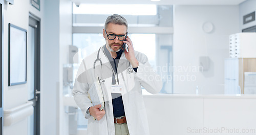 Image of Phone call, doctor and man walking in hospital, talking or conversation for healthcare. Smartphone, smile and medical professional with documents for communication, consulting or telehealth in clinic