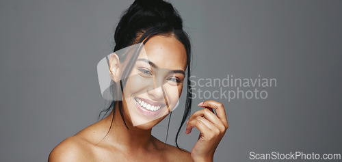 Image of Face, skincare and happy woman wink in studio isolated on a gray background. Portrait, natural beauty and model flirting in spa facial treatment for aesthetic, glow and cosmetic wellness for health